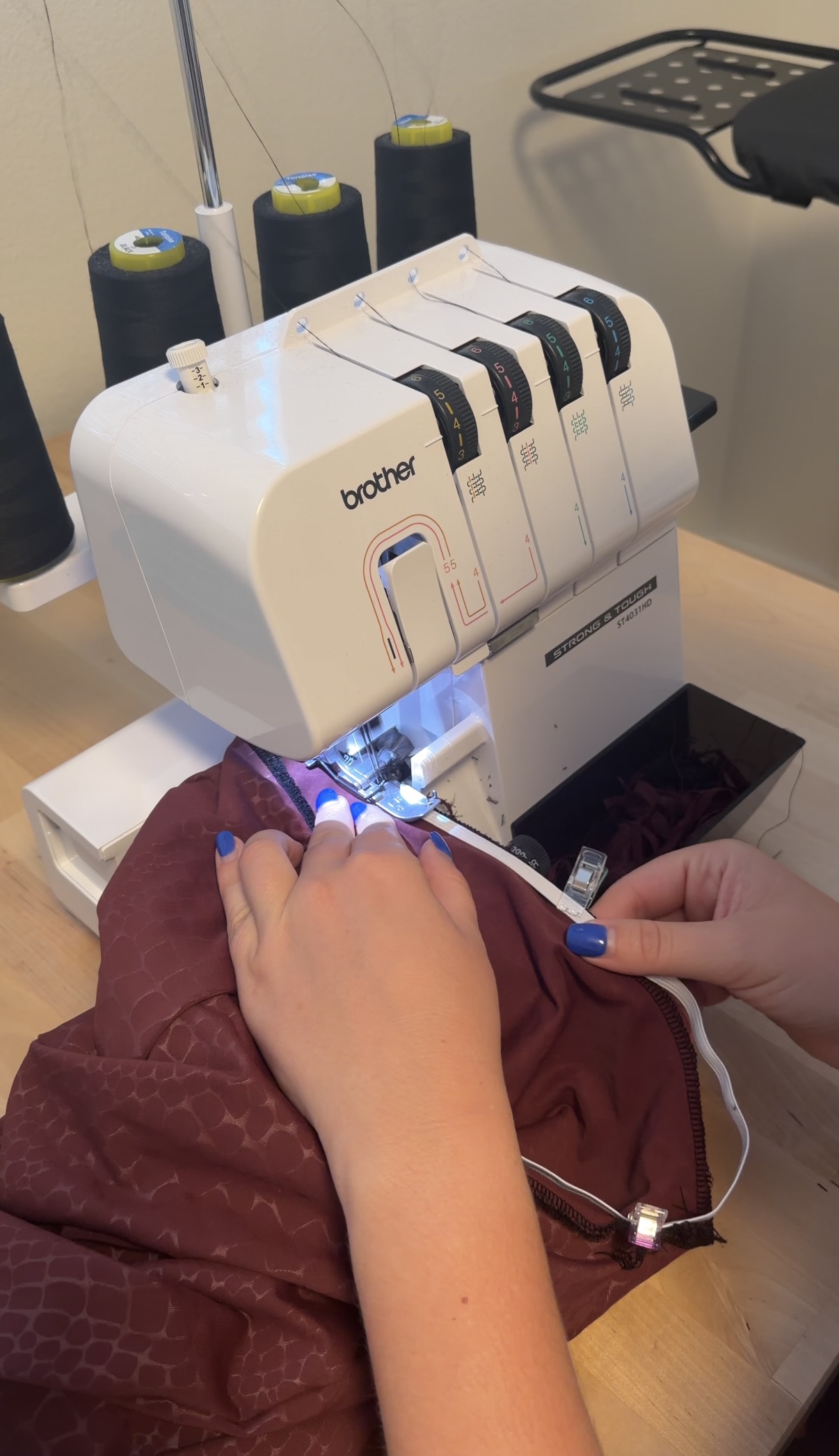 Serging the waistband elastic onto the skirt on Emily's serger
